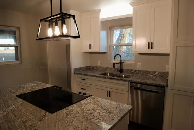 a kitchen with a sink stove and cabinets