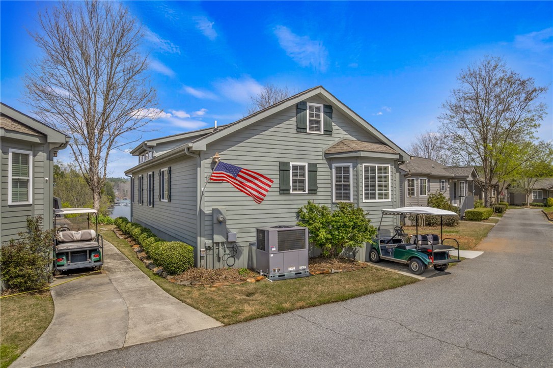 1230 Melton Road, Unit 93 West Union, SC 29696 - Photo 30 of 46 This charming residence features classic siding and a beautiful bay window, offering serene views of the lake.