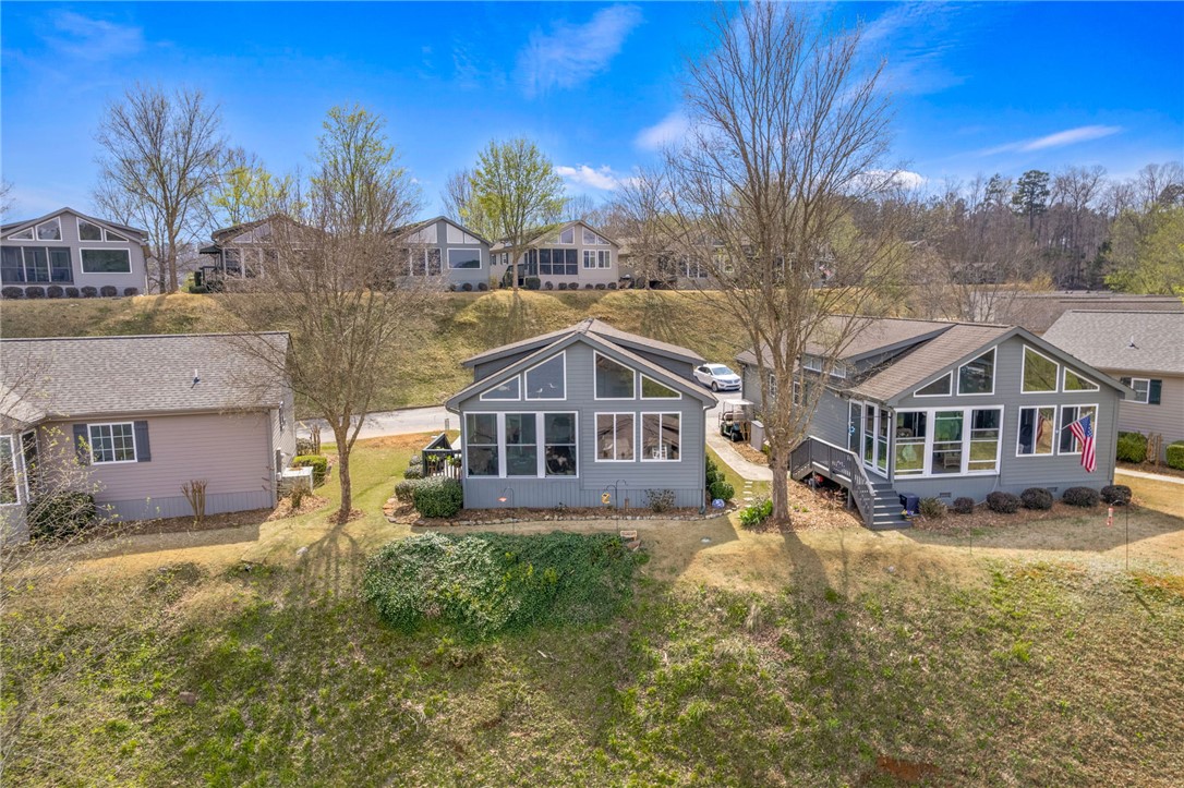 1230 Melton Road, Unit 93 West Union, SC 29696 - Photo 31 of 45 This hillside property features a charming exterior with expansive windows and a welcoming patio.