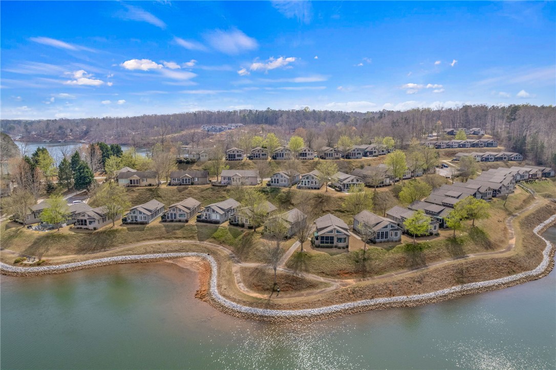 1230 Melton Road, Unit 93 West Union, SC 29696 - Photo 35 of 45 This elevated view captures a serene lakeside community nestled among verdant hillsides.