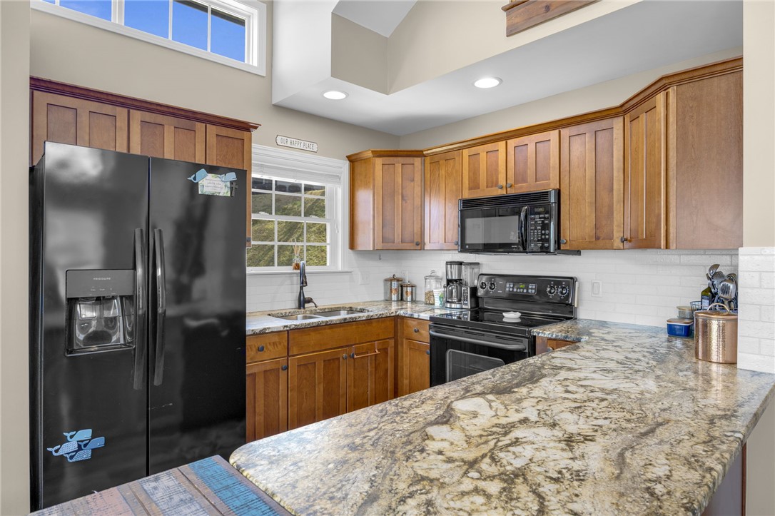 1230 Melton Road, Unit 93 West Union, SC 29696 - Photo 8 of 45 This spacious kitchen offers ample granite counter space, wood cabinetry, and integrated appliances.