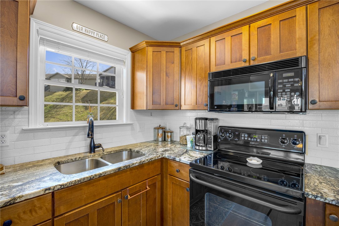 1230 Melton Road, Unit 93 West Union, SC 29696 - Photo 9 of 45 This bright kitchen features ample cabinetry, a double sink, and sleek black appliances.