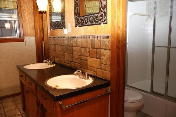 a bathroom with a sink toilet and a mirror