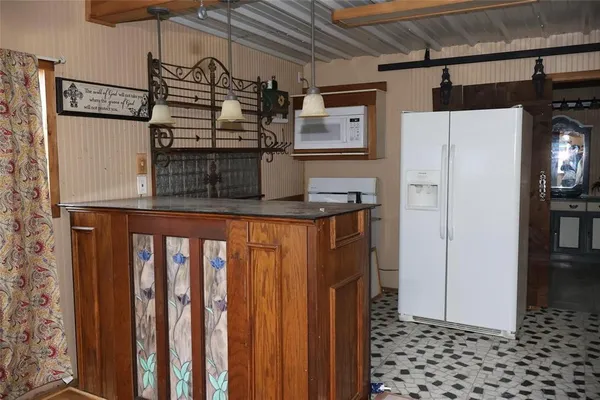 a kitchen with stainless steel appliances granite countertop a refrigerator and a stove