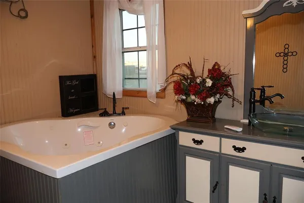 a bath tub sitting next to a bathroom sink