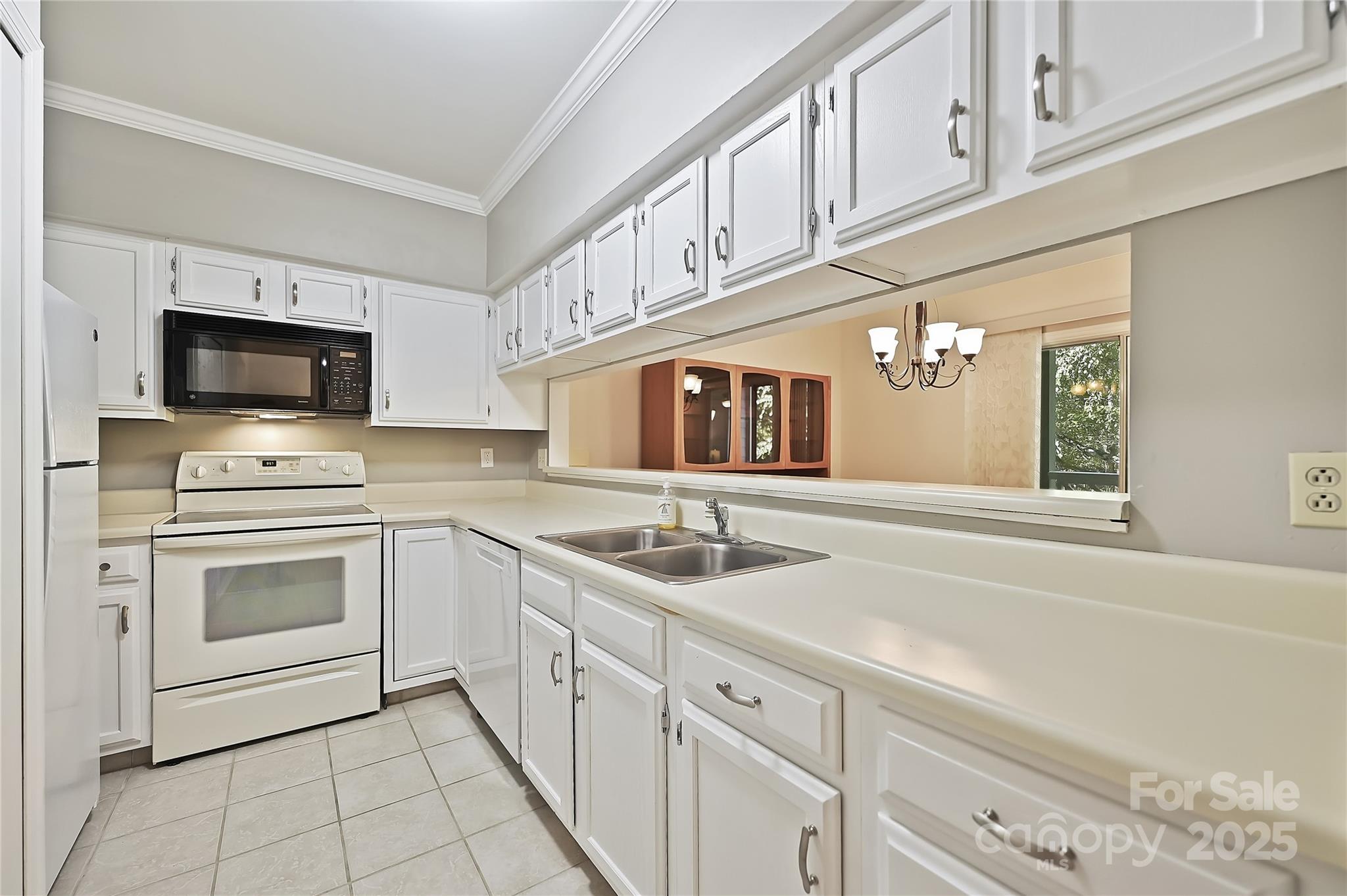 19901 Henderson Road, Unit C Cornelius, NC 28031 - Photo 11 of 42 a kitchen with granite countertop a sink stainless steel appliances and white cabinets