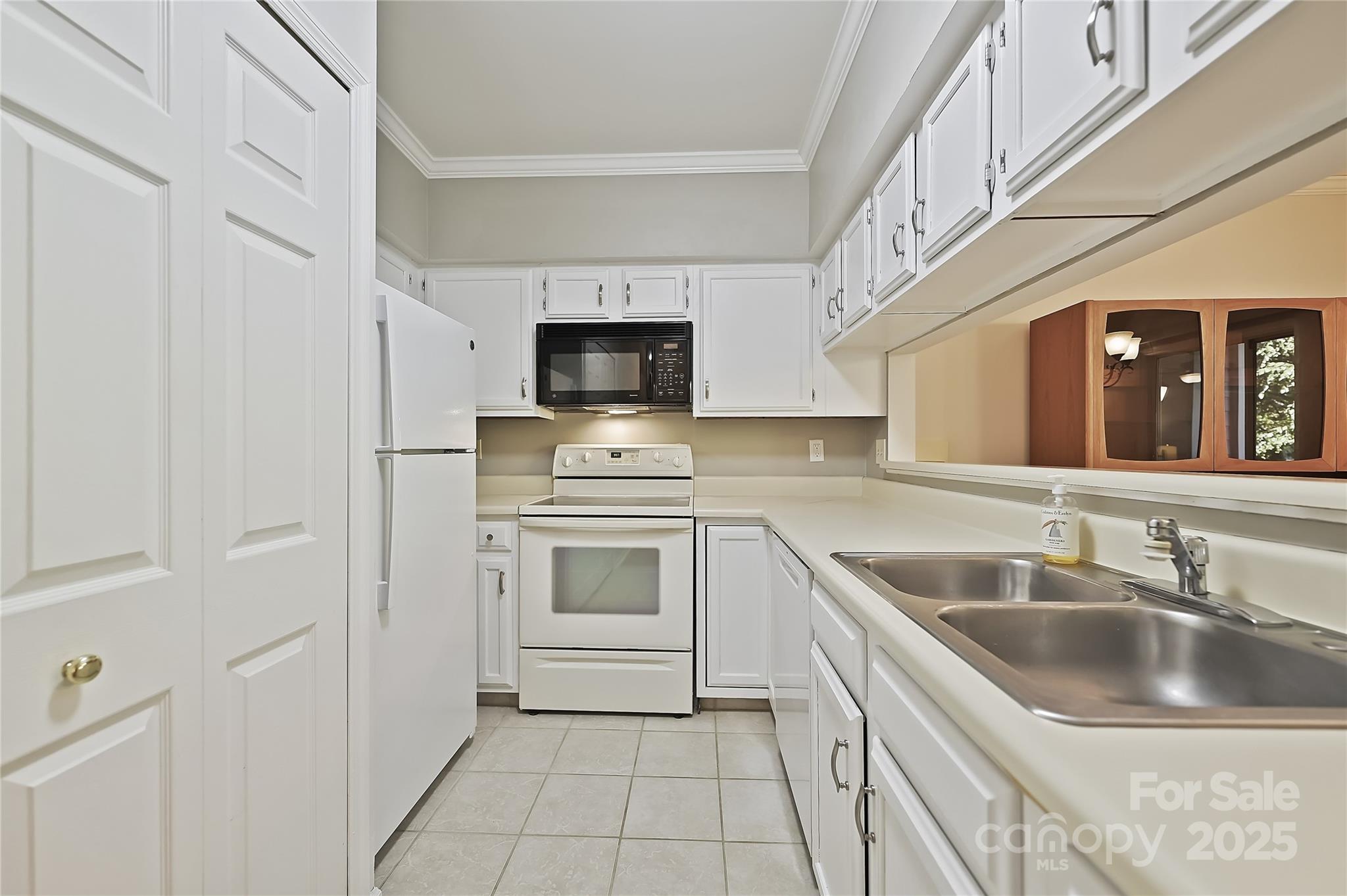 19901 Henderson Road, Unit C Cornelius, NC 28031 - Photo 12 of 42 a kitchen with cabinets stainless steel appliances and a counter space