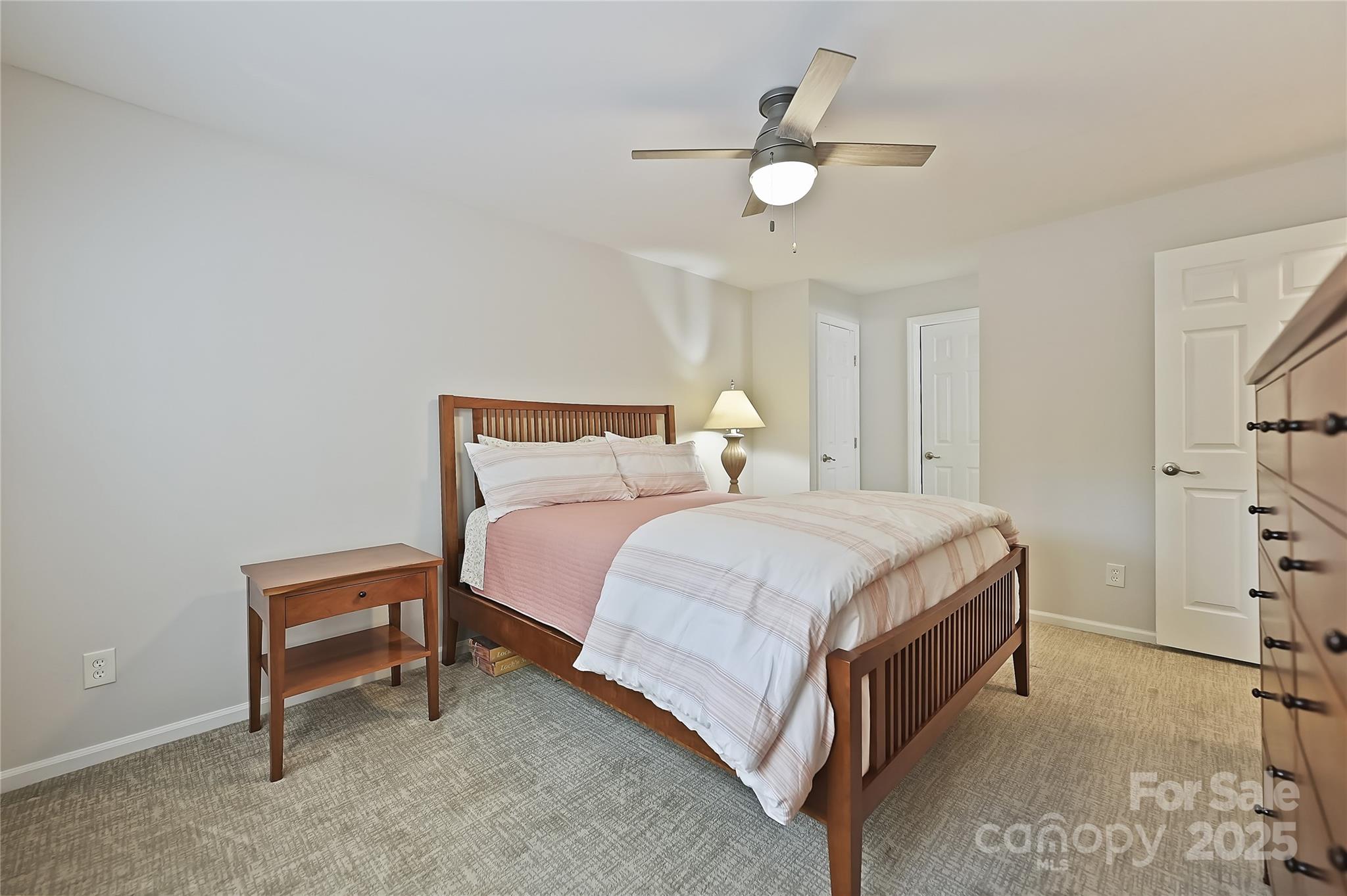 19901 Henderson Road, Unit C Cornelius, NC 28031 - Photo 23 of 42 a bedroom with a bed and a ceiling fan