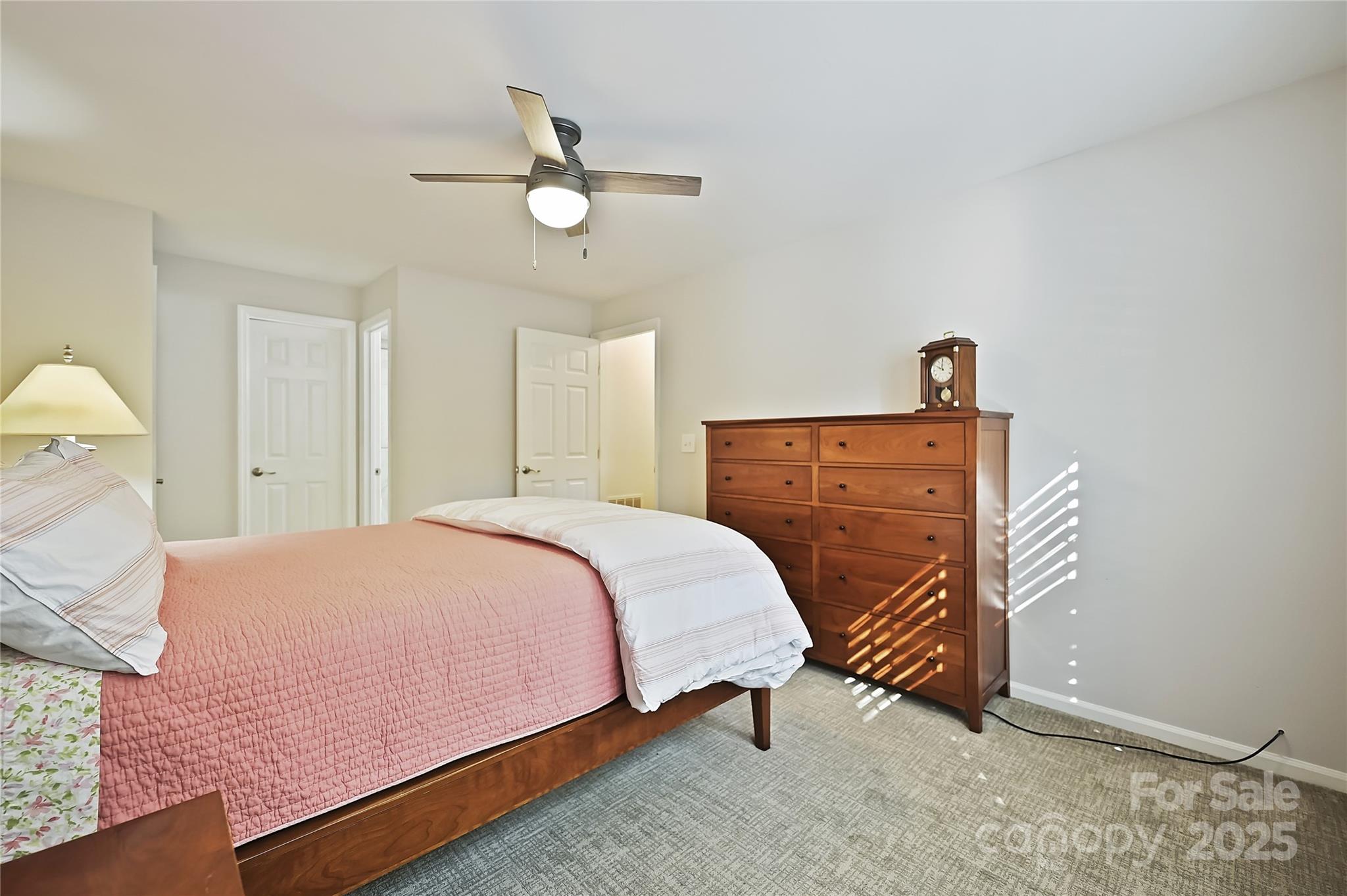 19901 Henderson Road, Unit C Cornelius, NC 28031 - Photo 24 of 42 a spacious bedroom with a bed and a chandelier
