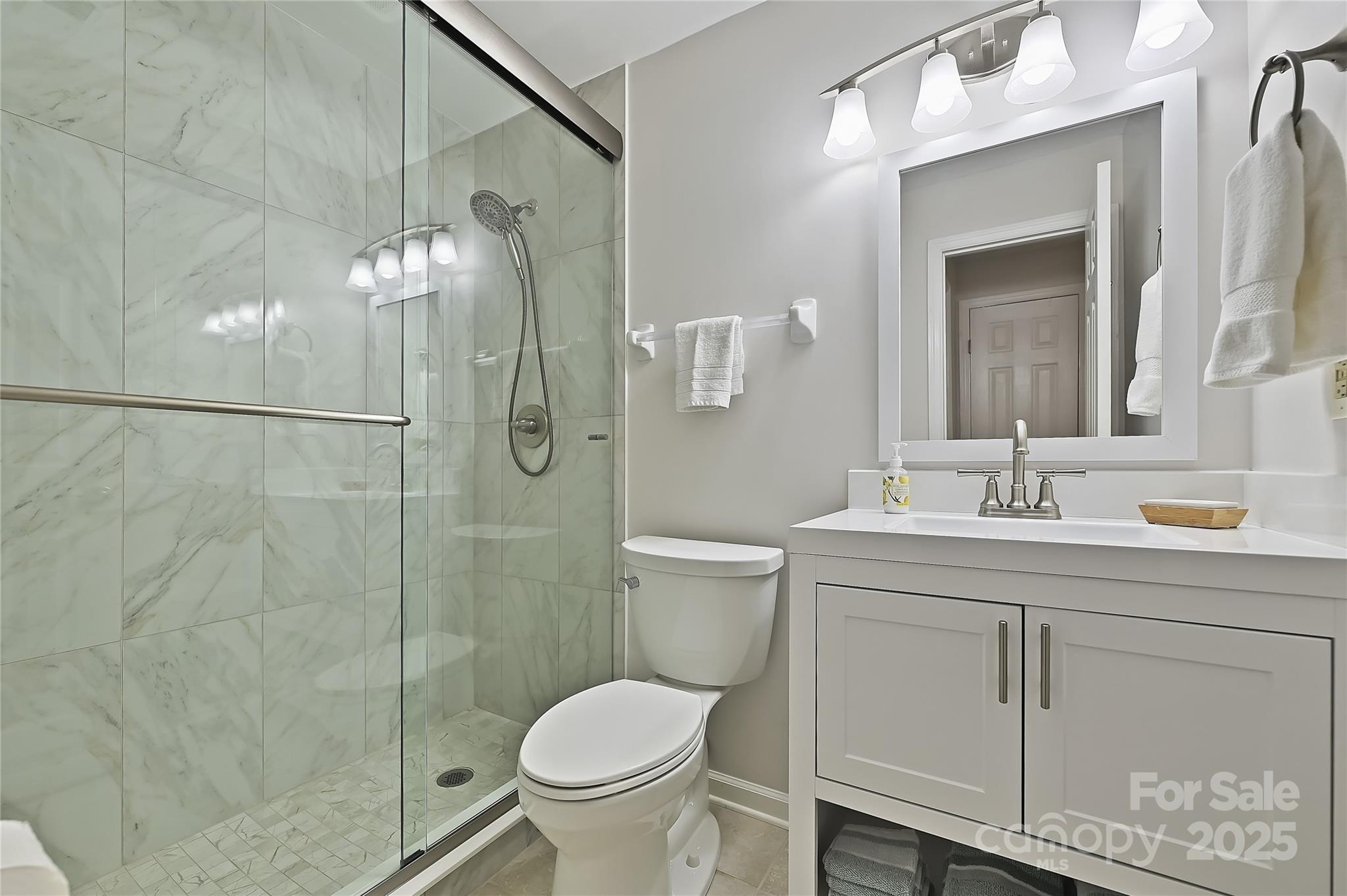 19901 Henderson Road, Unit C Cornelius, NC 28031 - Photo 25 of 42 a bathroom with a granite countertop sink toilet and shower