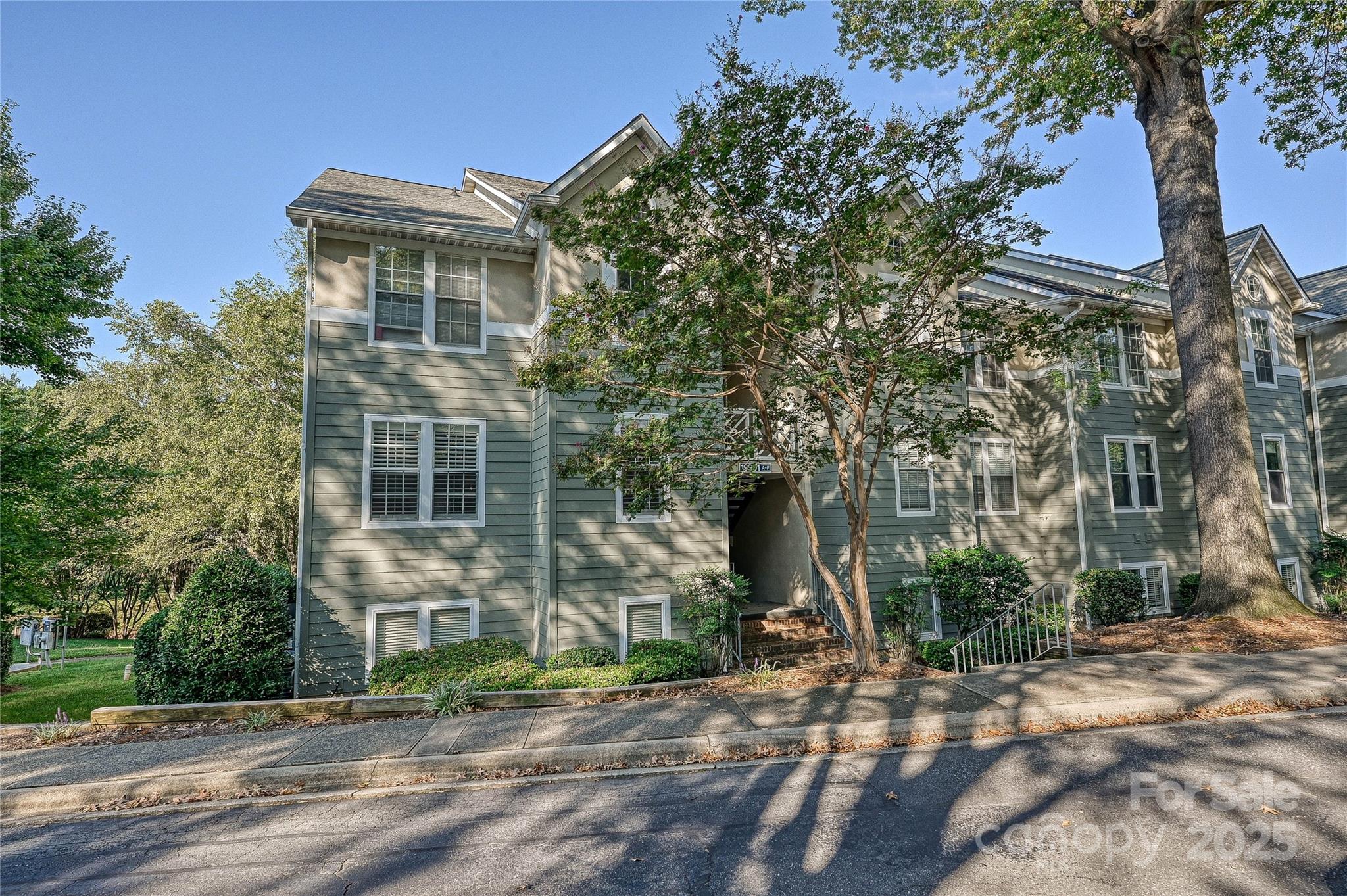 19901 Henderson Road, Unit C Cornelius, NC 28031 - Photo 3 of 42 a front view of a house with a yard