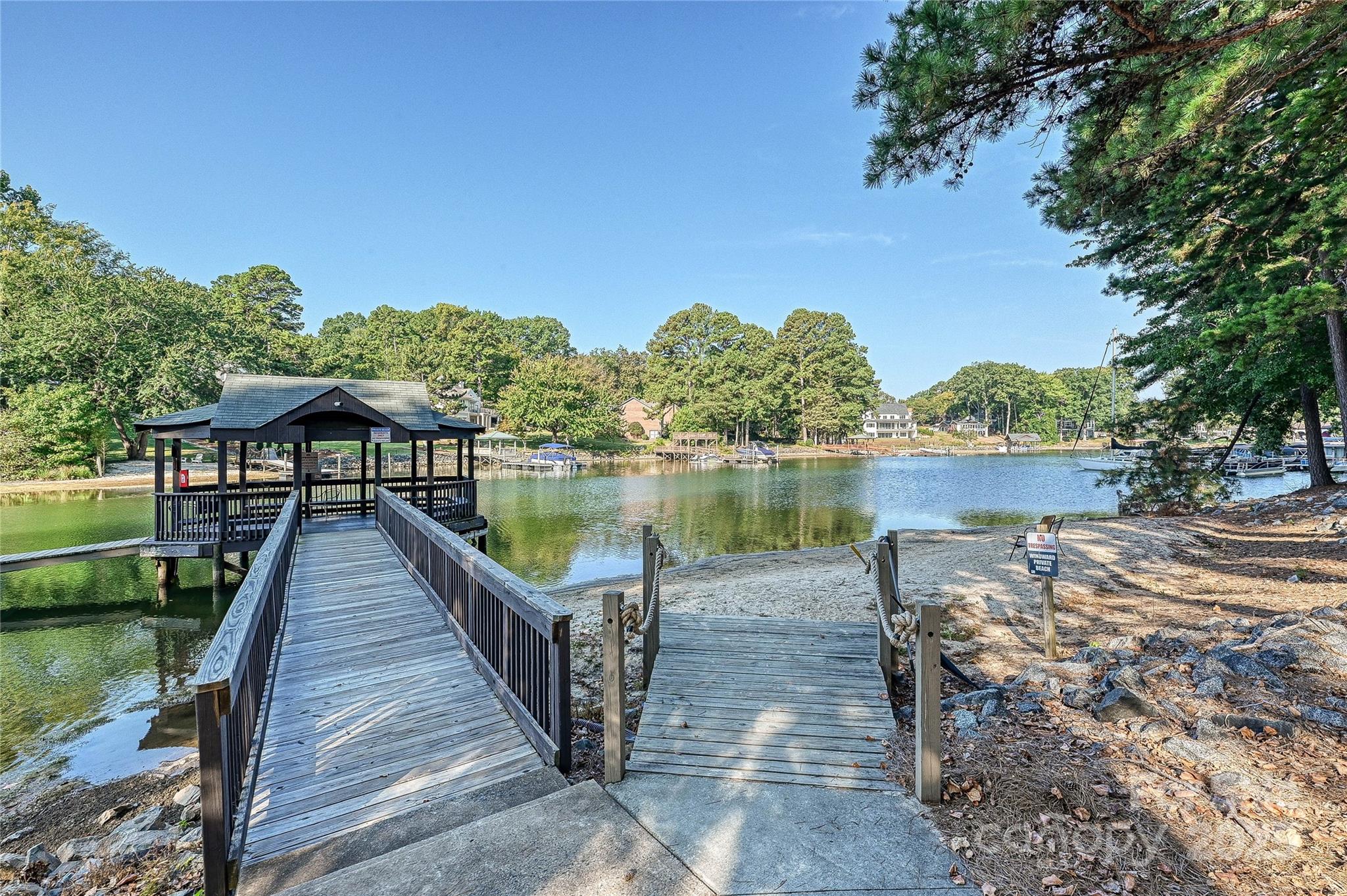 19901 Henderson Road, Unit C Cornelius, NC 28031 - Photo 38 of 42 a lake view with a wooden fence and floor