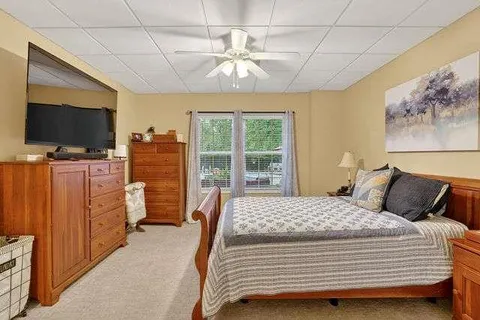 a bedroom with a bed and flat screen tv