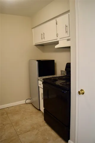 a kitchen with stainless steel appliances granite countertop a stove and a microwave