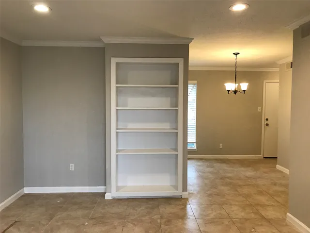 a view of an empty room with a cabinet