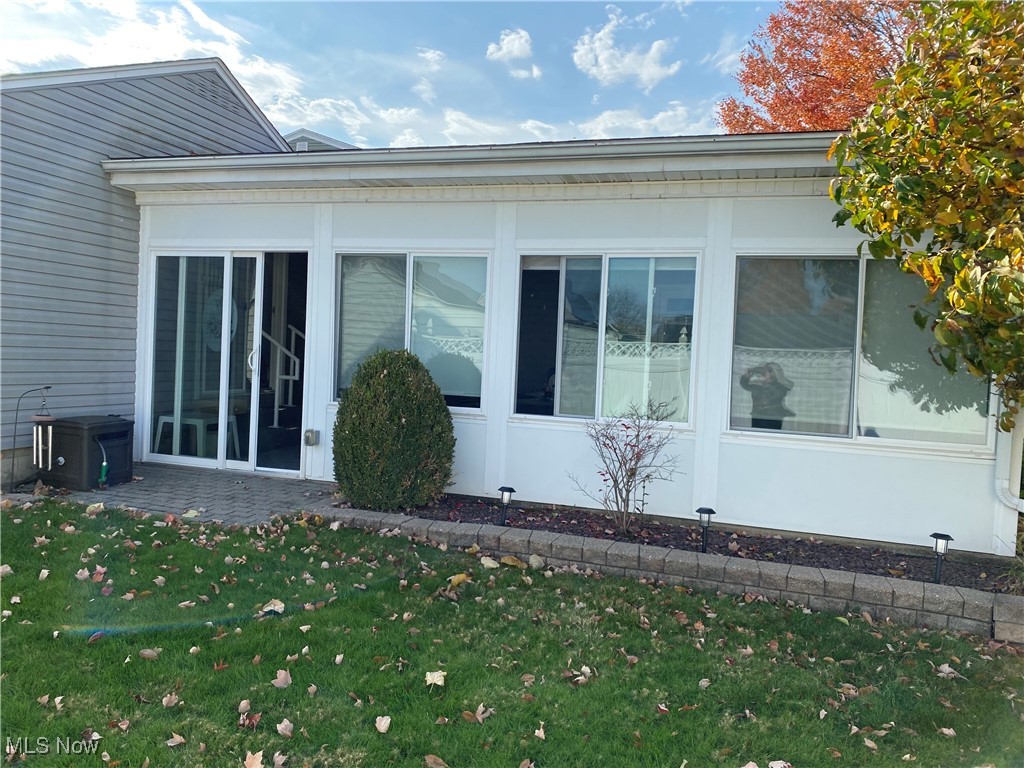 421 Omar Street Struthers, OH 44471 - Photo 29 of 31 View of side of home featuring a yard and a sunroom