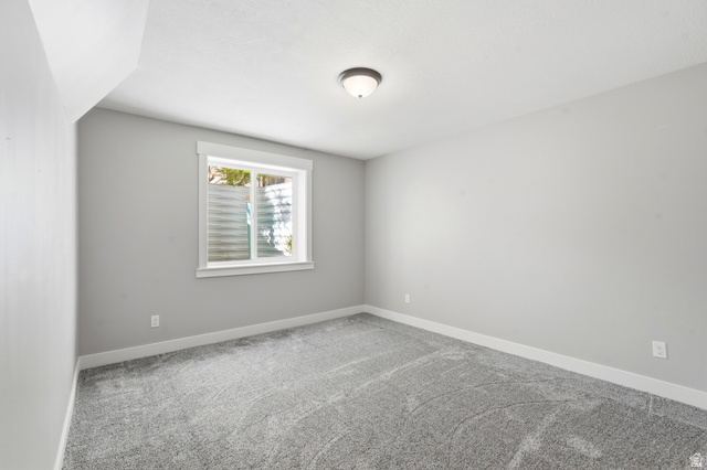 338 Windy Rdg Drive Smithfield, UT 84335 - Photo 49 of 63 Room featuring light grey wall paint, plush grey carpeting, white baseboards, and a white-framed window