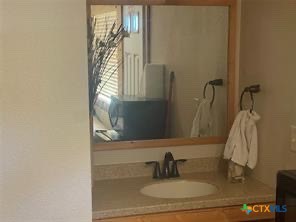 1104 Rorem Avenue Palacios, TX 77465 - Photo 11 of 17 a bathroom with a sink and a mirror
