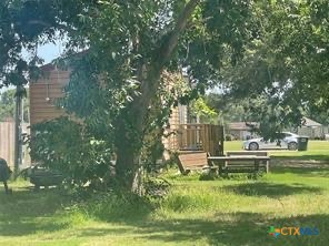 1104 Rorem Avenue Palacios, TX 77465 - Photo 5 of 17 a view of a house with a yard table and chairs