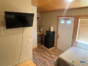 1104 Rorem Avenue Palacios, TX 77465 - Photo 10 of 17 a bedroom with a bed and a television in it