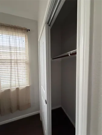 a view of a hallway to a livingroom and a couch