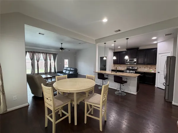 a view of a dining room with furniture and wooden floor