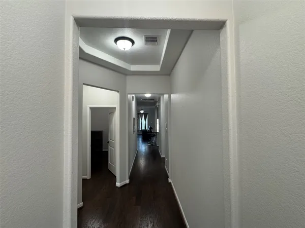 a view of hallway with wooden floor
