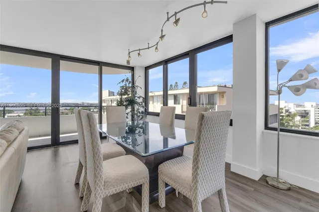 a view of a livingroom with wooden floor and furniture