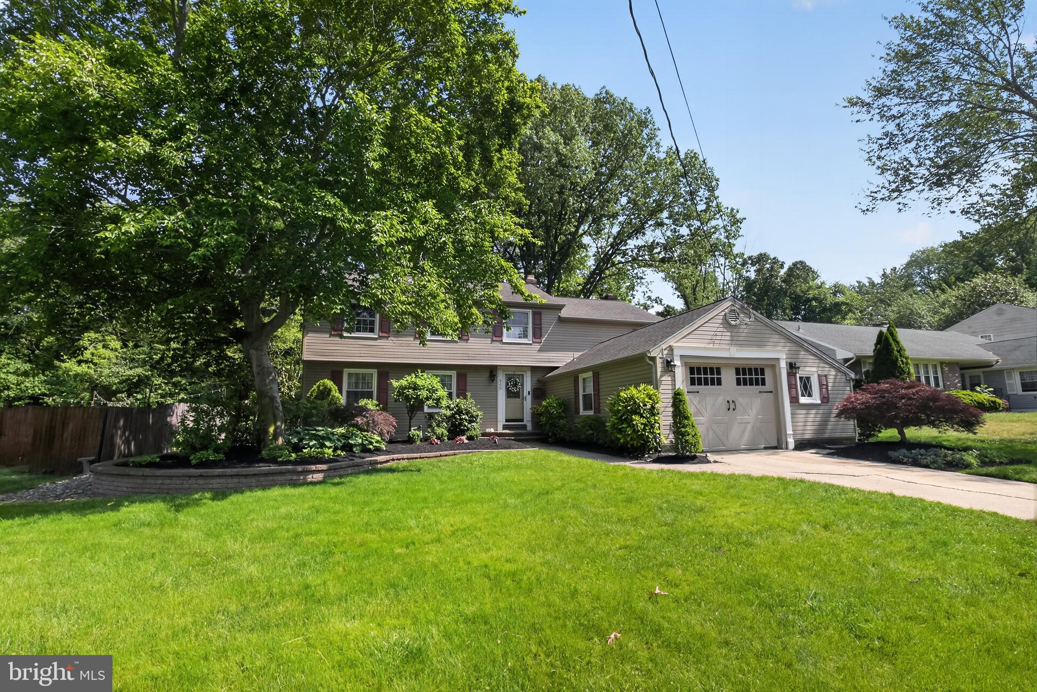 549 Covered Bridge Road Cherry Hill, NJ 08034 - Photo 15 of 16 a front view of a house with a garden and trees