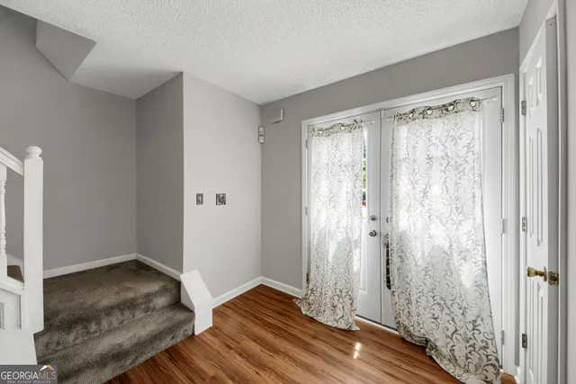 a view of wooden floor and closet in a room