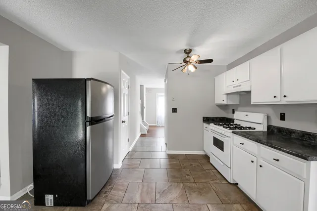 a kitchen with stainless steel appliances a refrigerator sink and cabinets