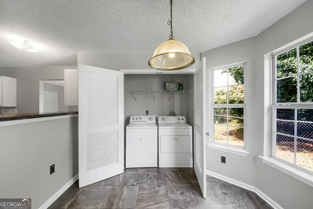 a view of storage and utility room with a window