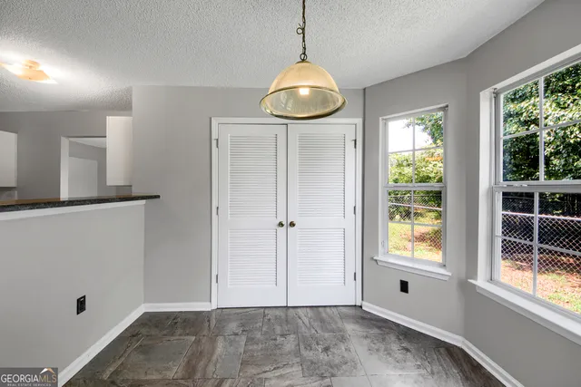 a view of an entryway with wooden floor and windows