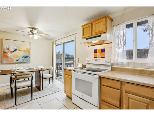 a kitchen with stainless steel appliances a stove a sink and cabinets