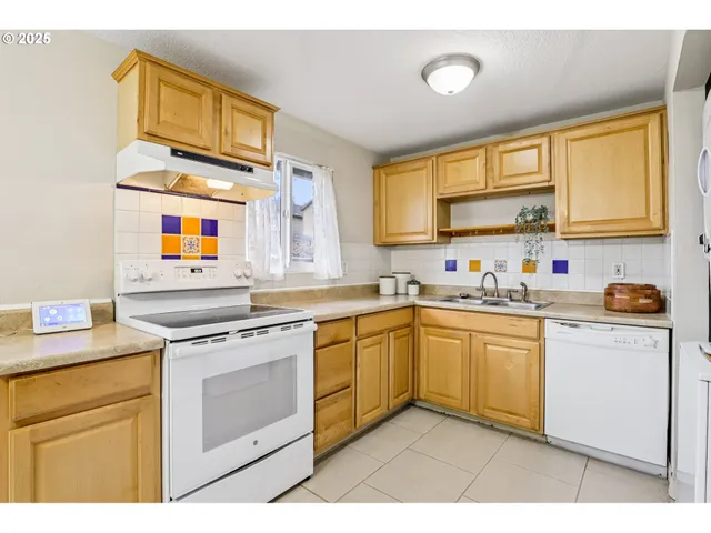 a kitchen with stainless steel appliances granite countertop a sink and cabinets