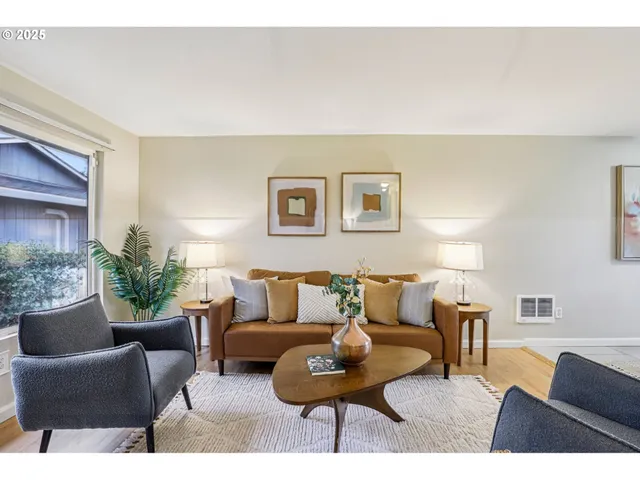 a living room with furniture and a potted plant