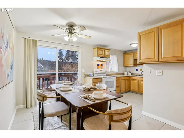 a kitchen with a table chairs and white cabinets