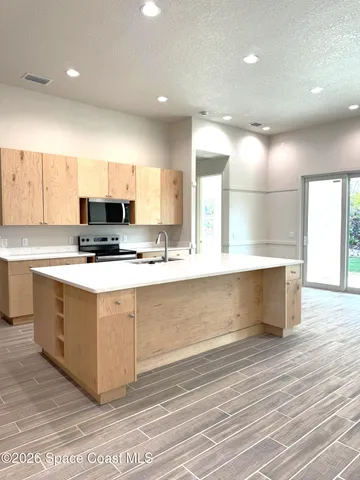 a kitchen with stainless steel appliances a stove top oven and cabinets