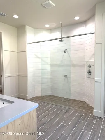 a bathroom with a sink a mirror and a shower