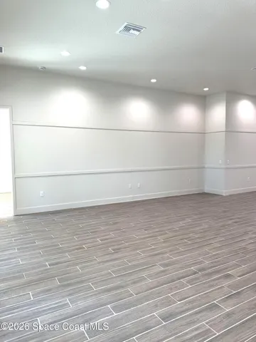 a view of a room with wooden floor and window