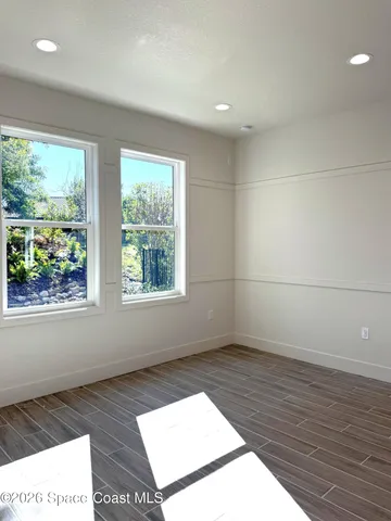 a view of an empty room and wooden floor