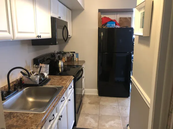 a kitchen with a refrigerator and a sink