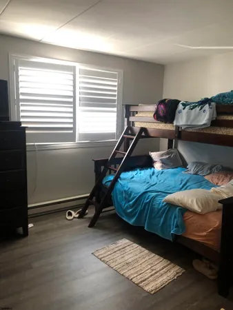 a living room with furniture gym equipment and a window