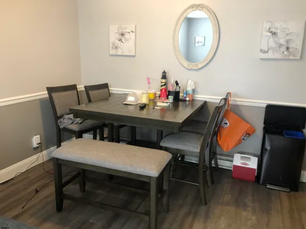 a view of a dining room with furniture and wooden floor
