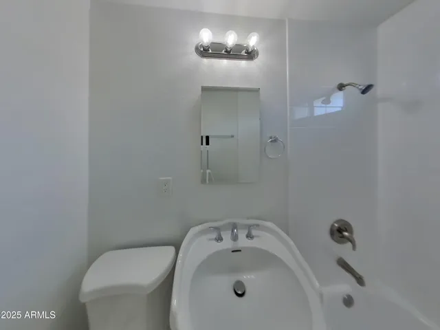 a bathroom with a sink and mirror