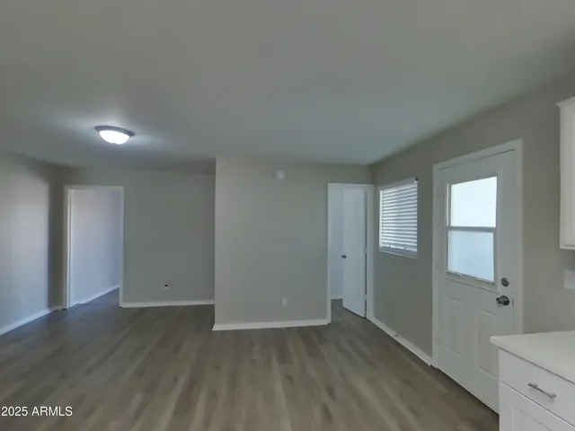 a kitchen with a refrigerator a stove top oven and white cabinets