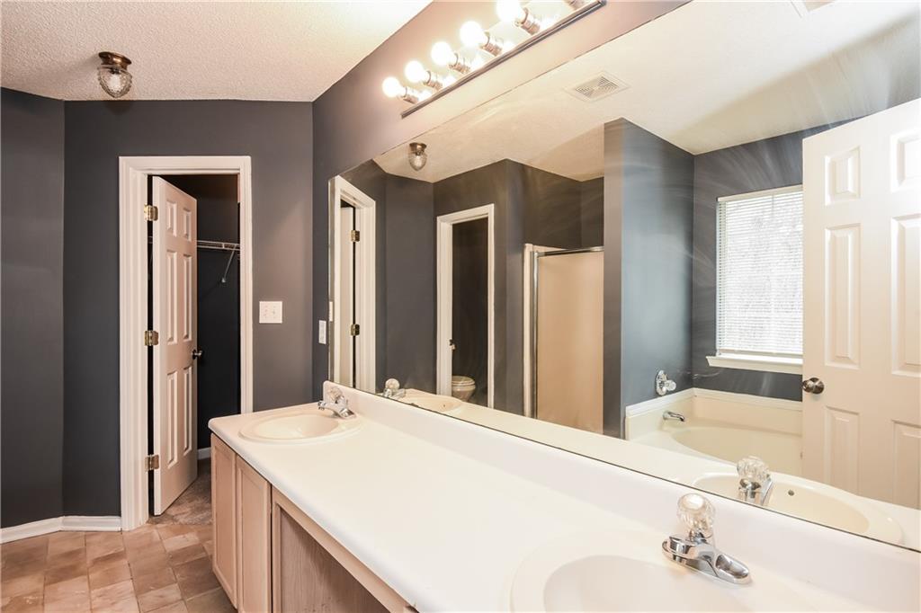 2716 River Tree Drive Decatur, GA 30034 - Photo 17 of 27 a bathroom with a granite countertop sink and a large mirror