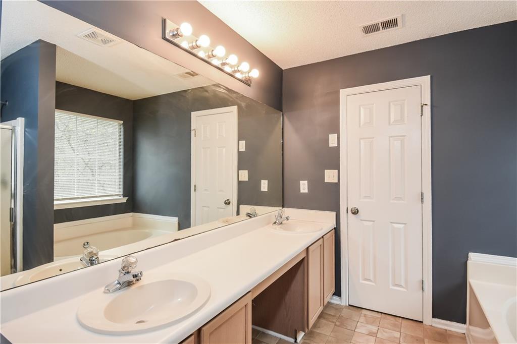 2716 River Tree Drive Decatur, GA 30034 - Photo 18 of 27 a spacious bathroom with a bathtub shower sink and mirror
