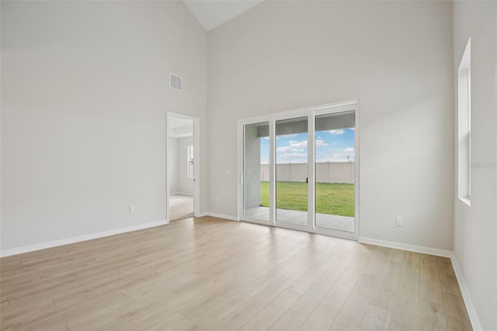 10167 Hidden Hammock Loop Parrish, FL 34221 - Photo 11 of 42 an empty room with wooden floor and windows