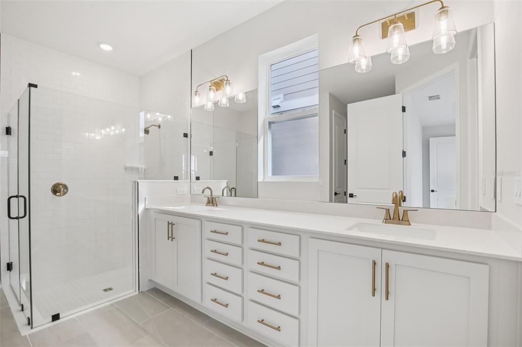10167 Hidden Hammock Loop Parrish, FL 34221 - Photo 25 of 42 a bathroom with a double vanity sink mirror and double